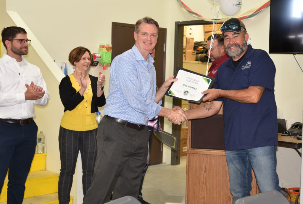 Scott Davis recognizes the NAS Fallon CEMS implementation team, pictured with Tom Schrock. Also pictured are Thomas Langdon and Kathy Grimes.